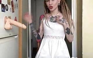 Cute tattooed teen enjoys a sex toy